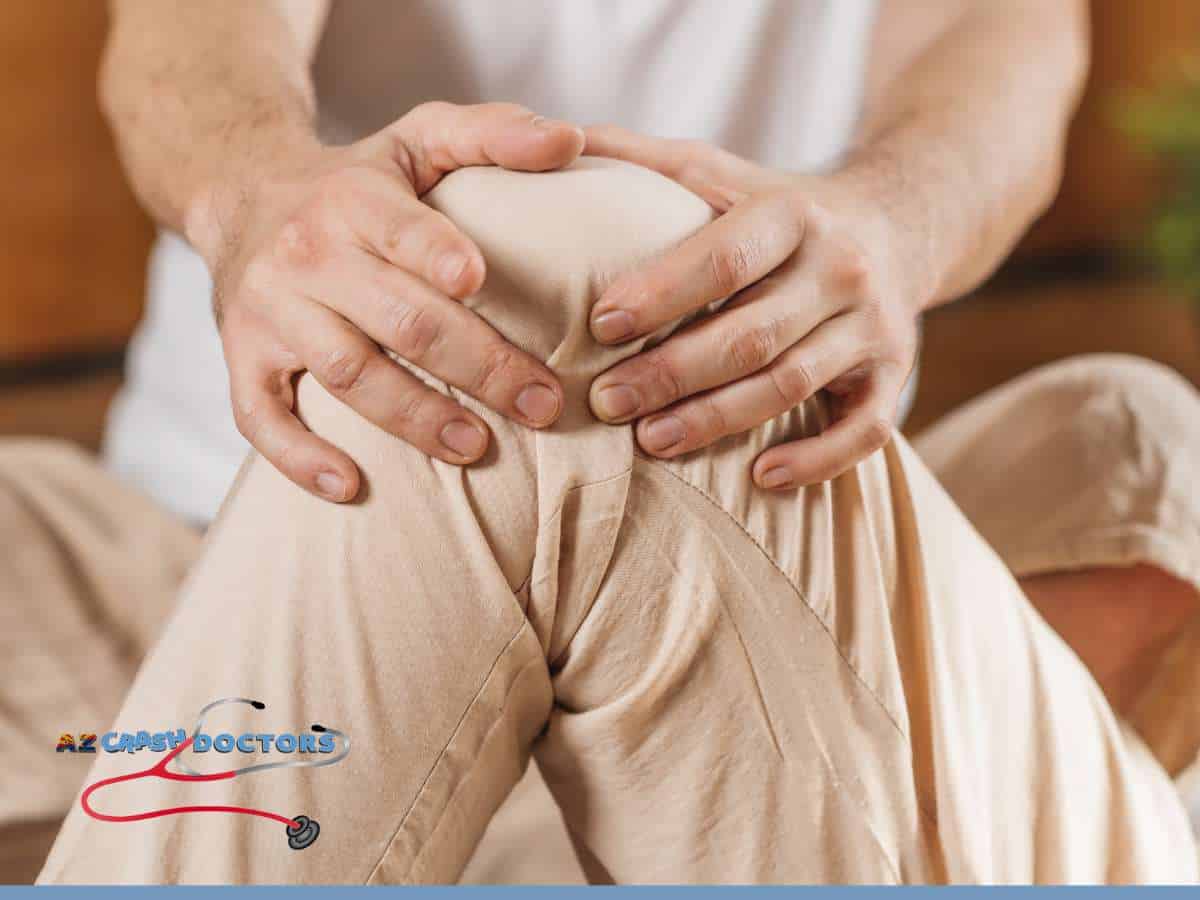 Man holding knee in pain, seeking Chiropractic Care after a car accident