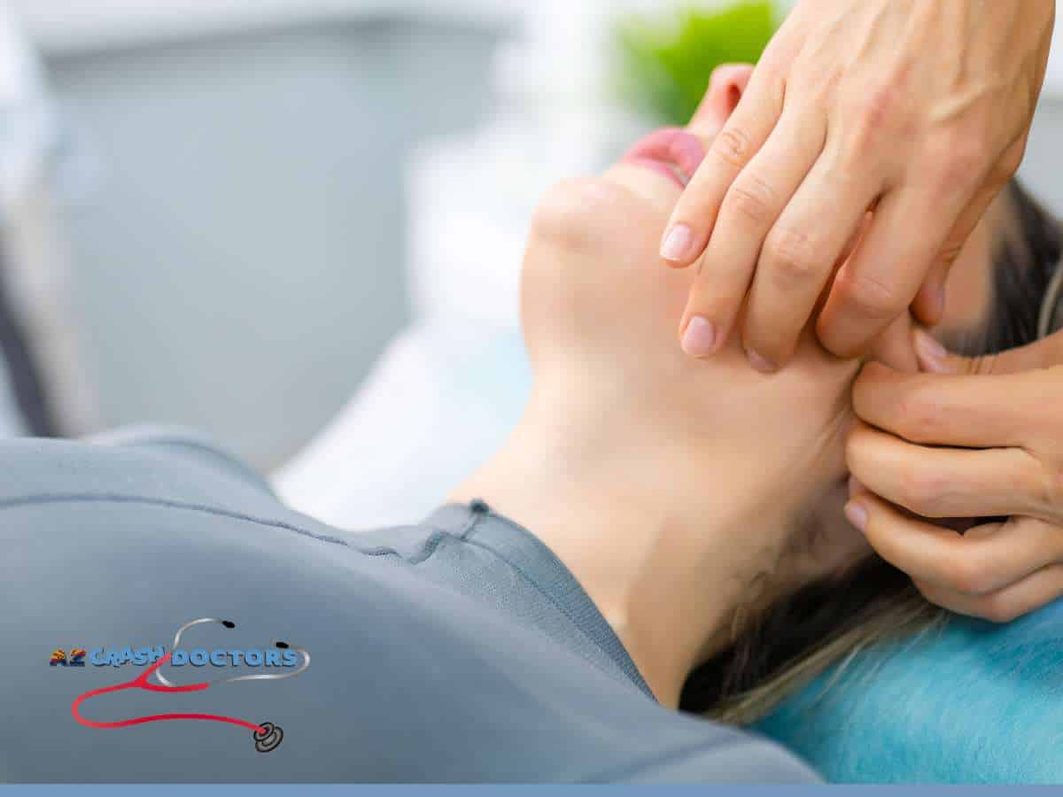 Chiropractor treating TMJ Pain with gentle jaw adjustment